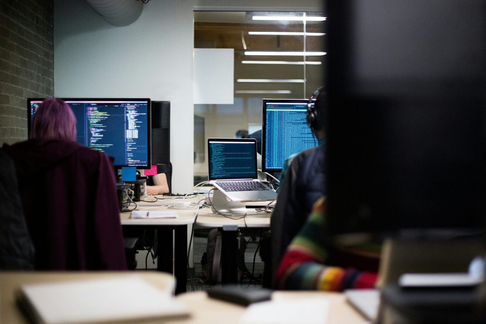 Analysts reviewing data on multiple monitors